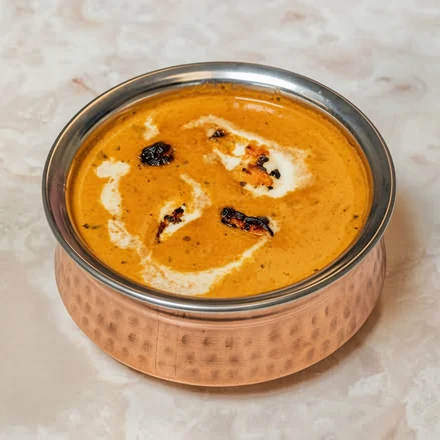 Butter chicken in a creamy orange curry sauce at Lutf Indo-Pak Cuisine