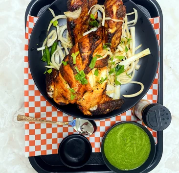 Seasoned cooked pieces with onions, citrus and green chutney at Lutf Indo-Pak Cuisine